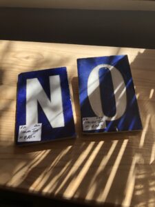 Blue tiles with N and O painted on them in white glaze