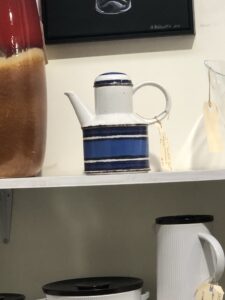 Blue and white striped tea or coffee pot with a circular handle