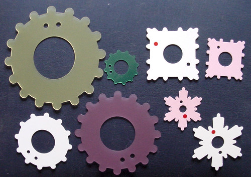 Flat plastic shapes with small spokes protruding from the edges.