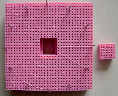 Hazel's Adjust-O-Peg loom set up as a flower loom with the pins in a circle, and the centre removed from the loom.
