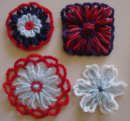 Circular, square, and star shaped yarn flowers.