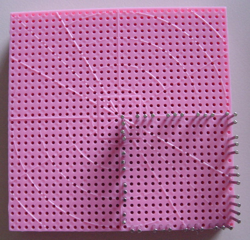 Hazel's Adjust-O-Peg loom set up with pins to weave a square on one quarter of the loom.