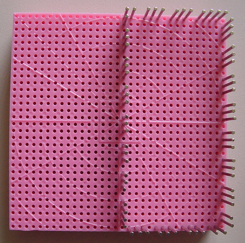 Hazel's Adjust-O-Peg loom set up with the pins to weave a rectangle covering one half of the loom.
