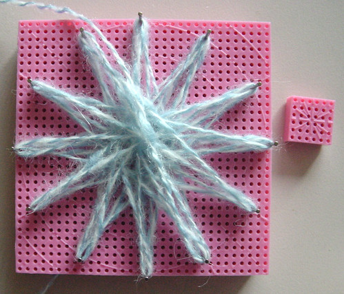 A flower loomed flower in progress.