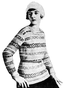 Girl wearing a fitted, long sleeved fairisle jumper/sweater.