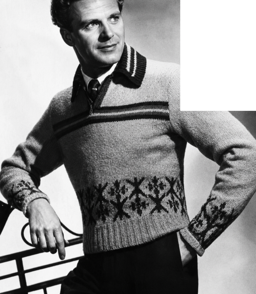 A man wearing a form fitting sweater/jumper with fair-isle patterned band across the bottom, plain body, and stripes near the neck opening.
The neck has a slit opening with coloured band up each side. It is finished with a ribbed shirt-collar worked in stripes to match the stripes across the front of the jumper.