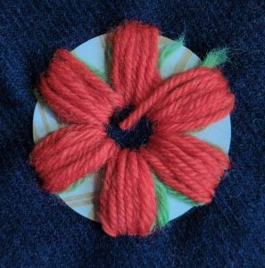 A second layer of red wool has been stitched over the first layer.