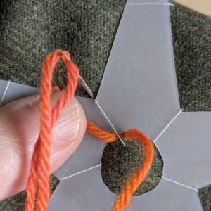 Stitching down through the fabric on the other side of the template.