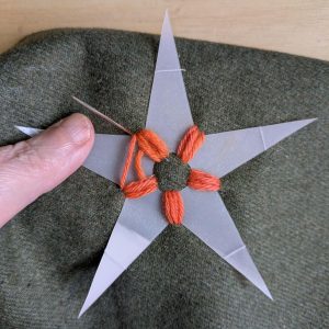 Beginning to stitch the first leg of the star.