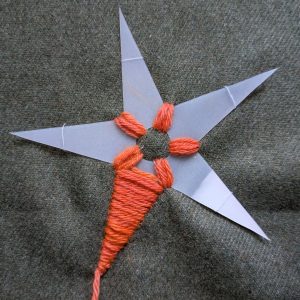 The first layer of stitching on the first leg of the star is complete.