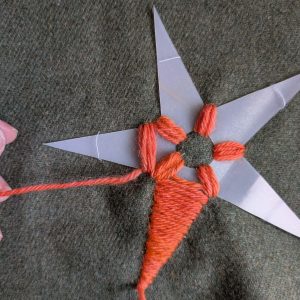 Stitching over the end to hold it in place.