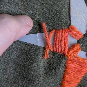 Beginning the next length of yarn, laying the new end over the old one.