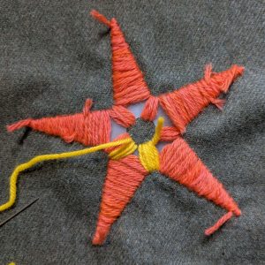Beginning the second layer of stitching over the top of the first, using a different colour.