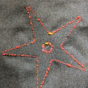 The back of the work, showing the second layer of stitches worked as close as possible to the first layer.