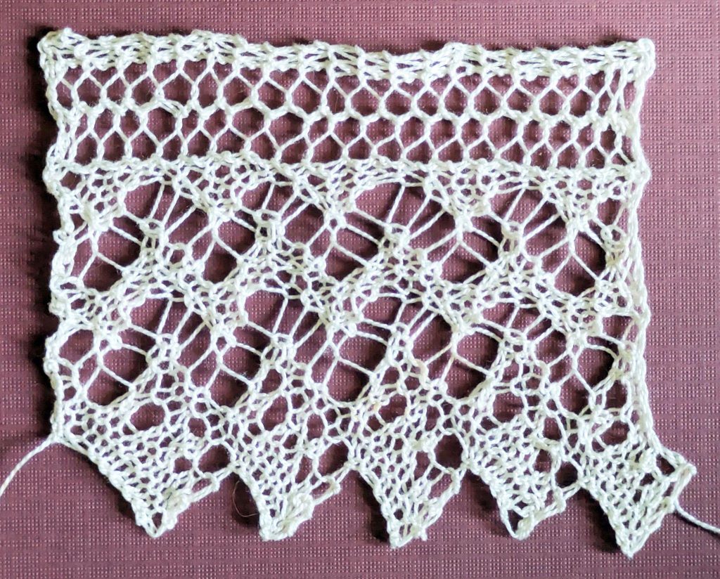 Knitted lace edging with two rows of zig-zag design made of eyelets.