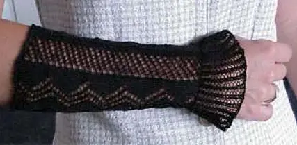 Lace knit wristers in black, with a flared lace cuff.